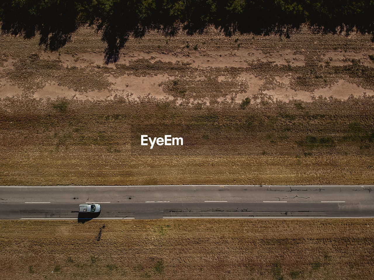 Aerial view of car moving on road