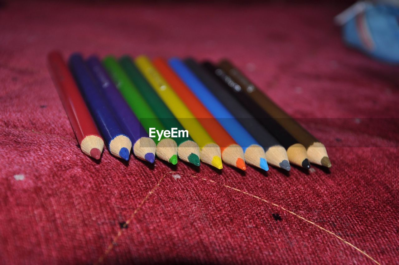 multi colored, pencil, colored pencil, writing instrument, indoors, no people, close-up, craft, red, still life, creativity, education, variation, selective focus, wood, table, pink, in a row