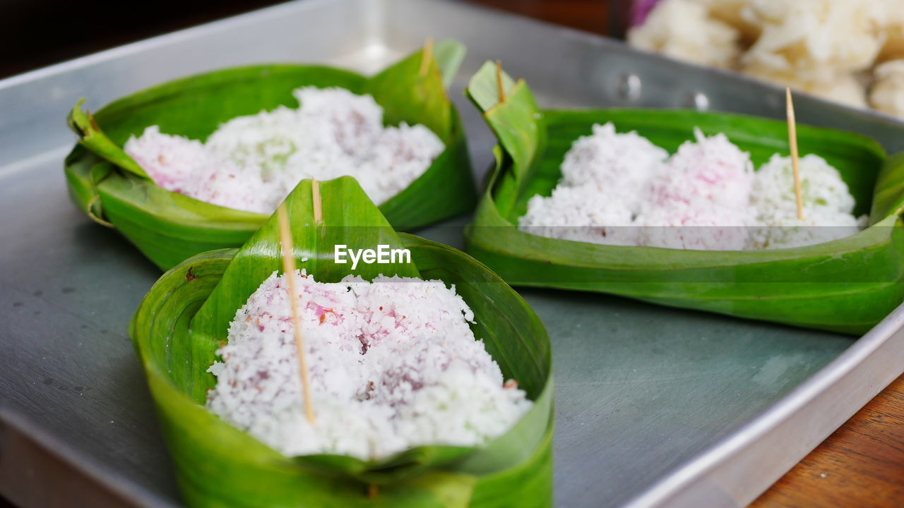 CLOSE-UP OF FOOD SERVED ON TABLE WITH LEAVES