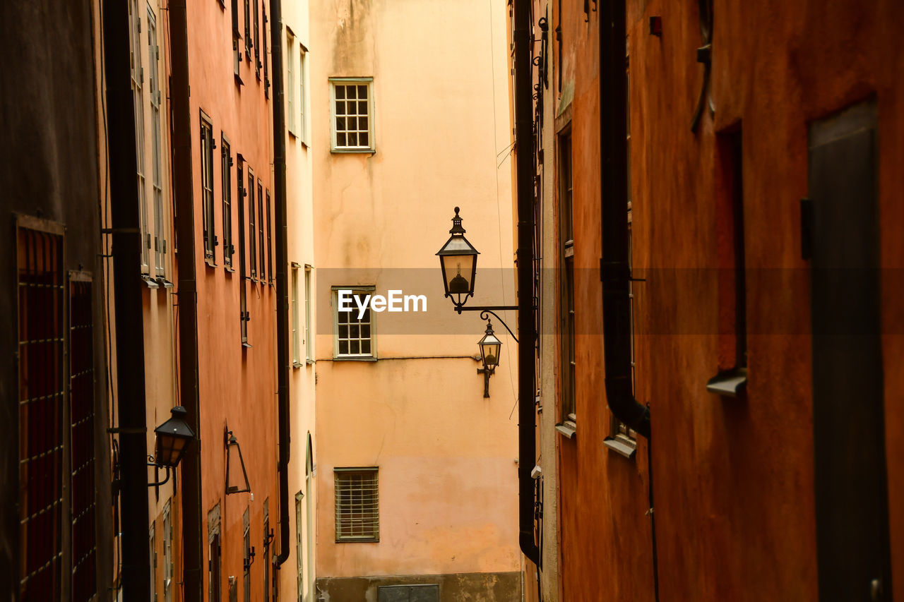 LOW ANGLE VIEW OF STREET LIGHT AMIDST BUILDINGS