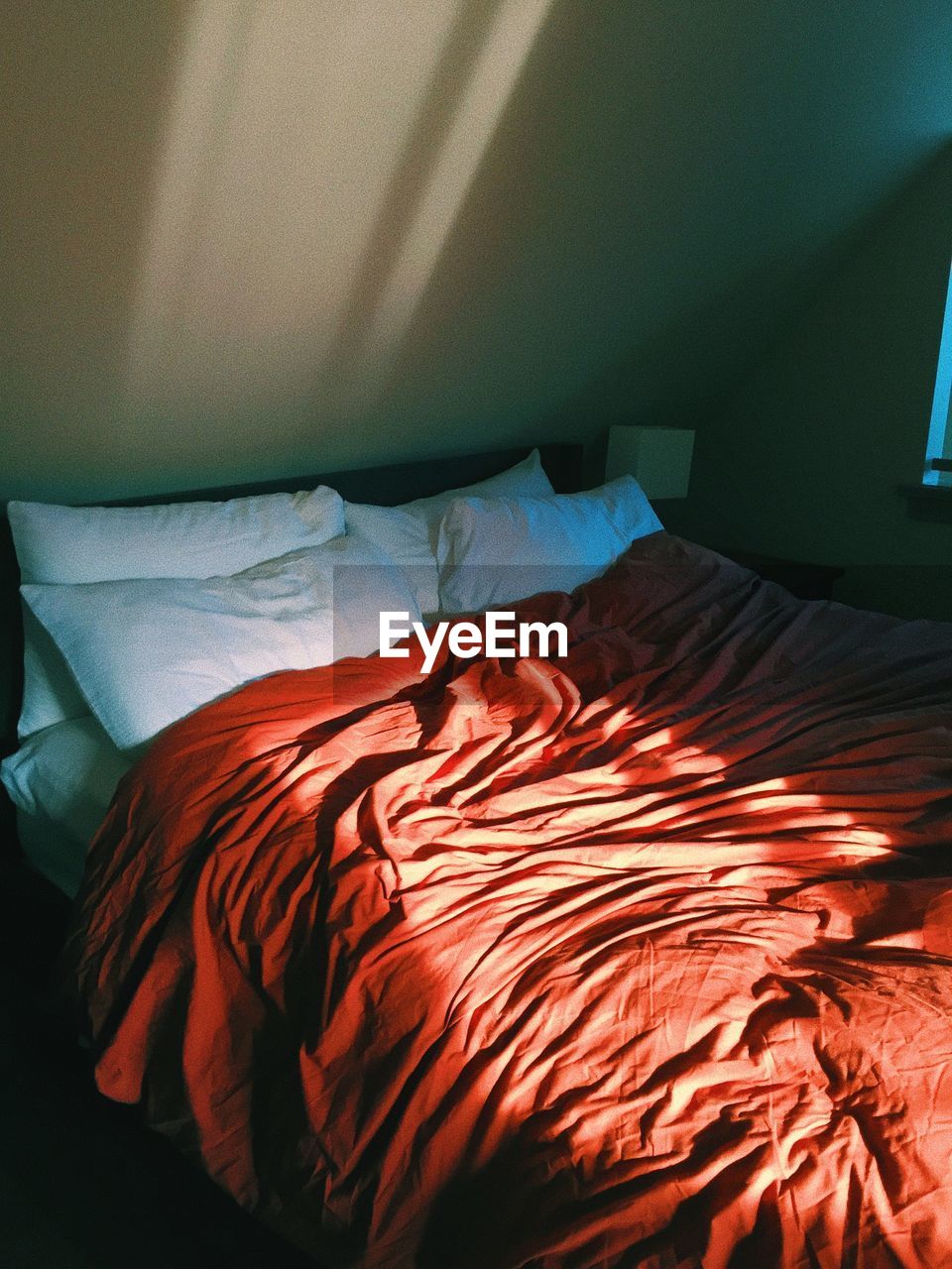 High angle view of messy bed at home