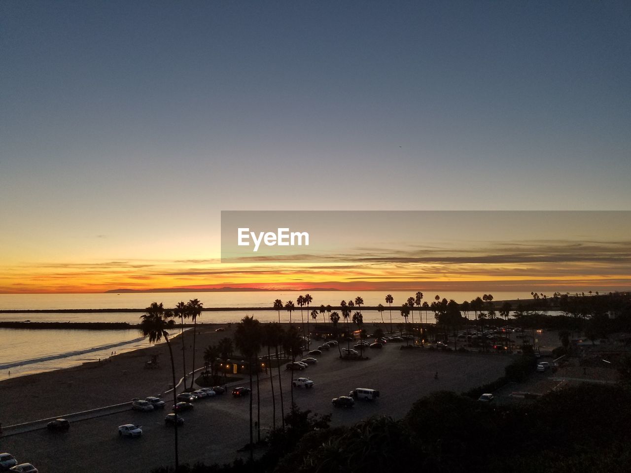 VIEW OF BEACH AGAINST SKY DURING SUNSET