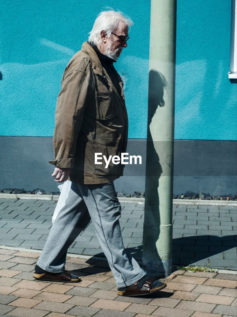 Low section of man walking on street