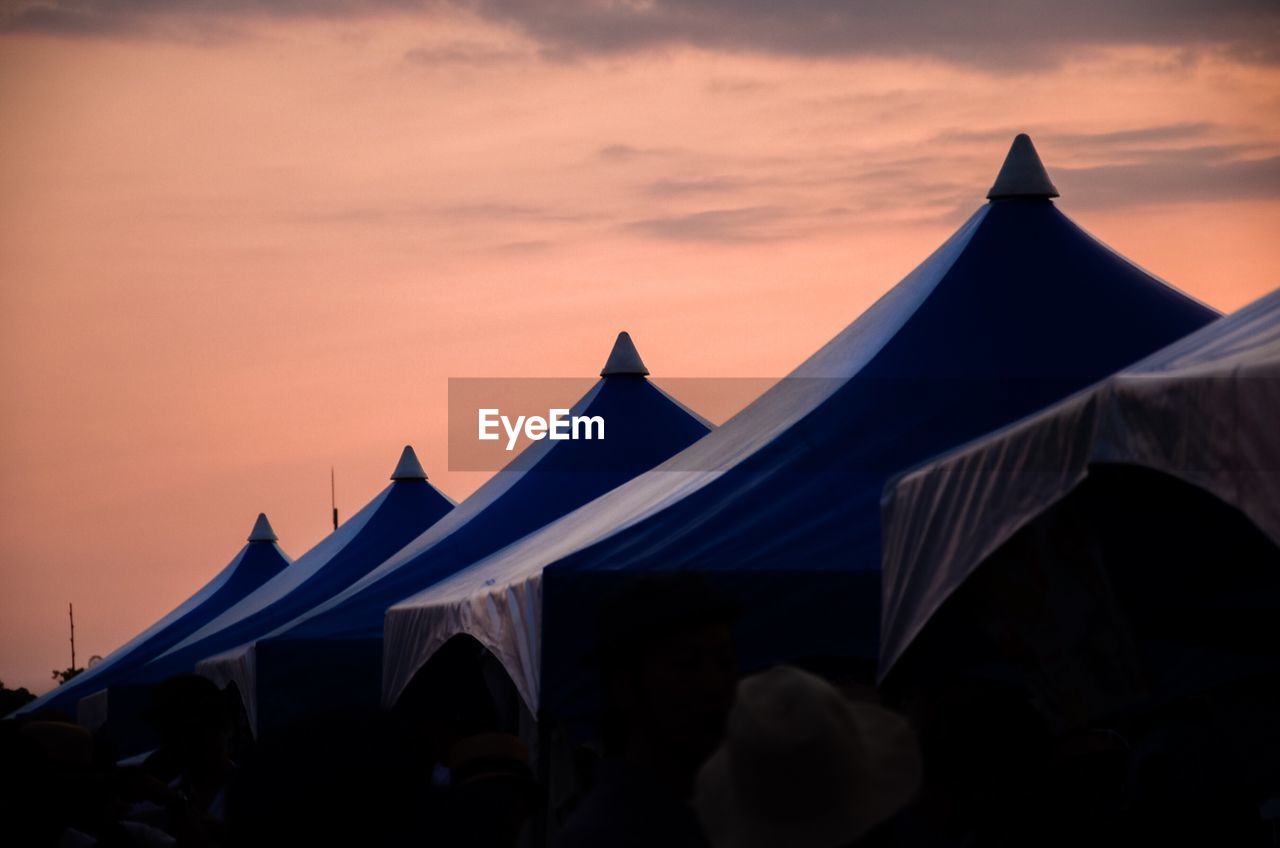 Tents against sky during sunset