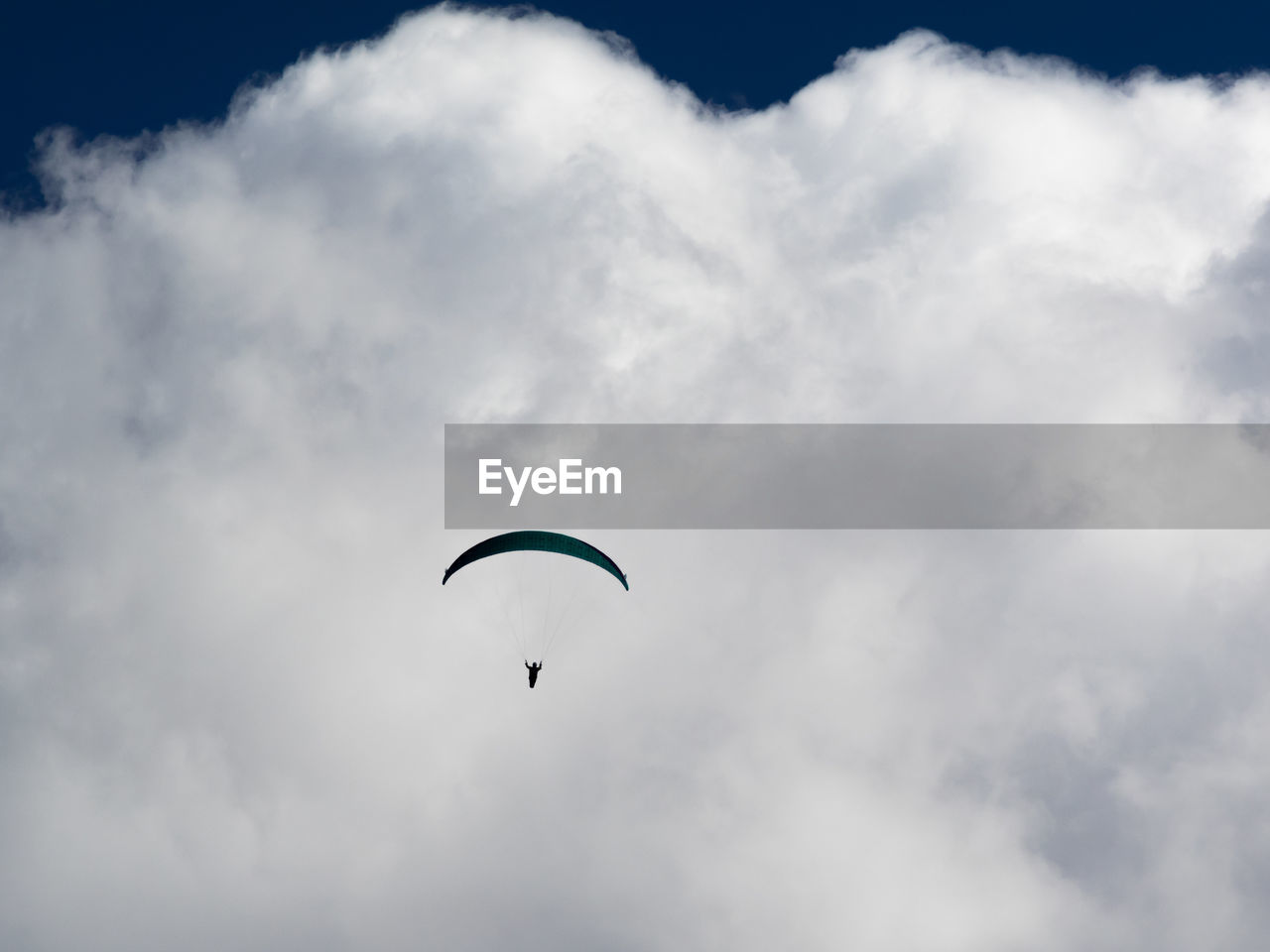 Low angle view of paragliding against sky