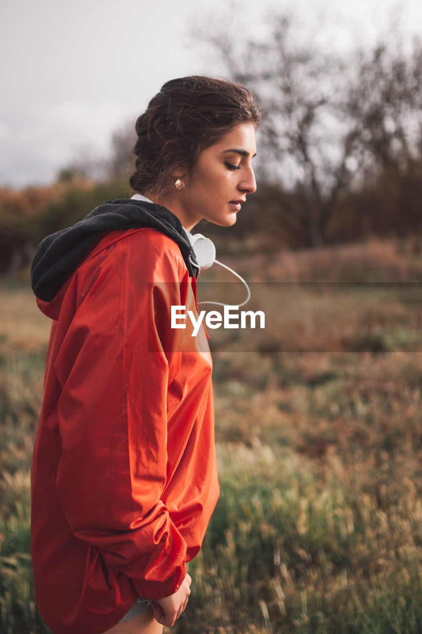 Side view of woman standing on field