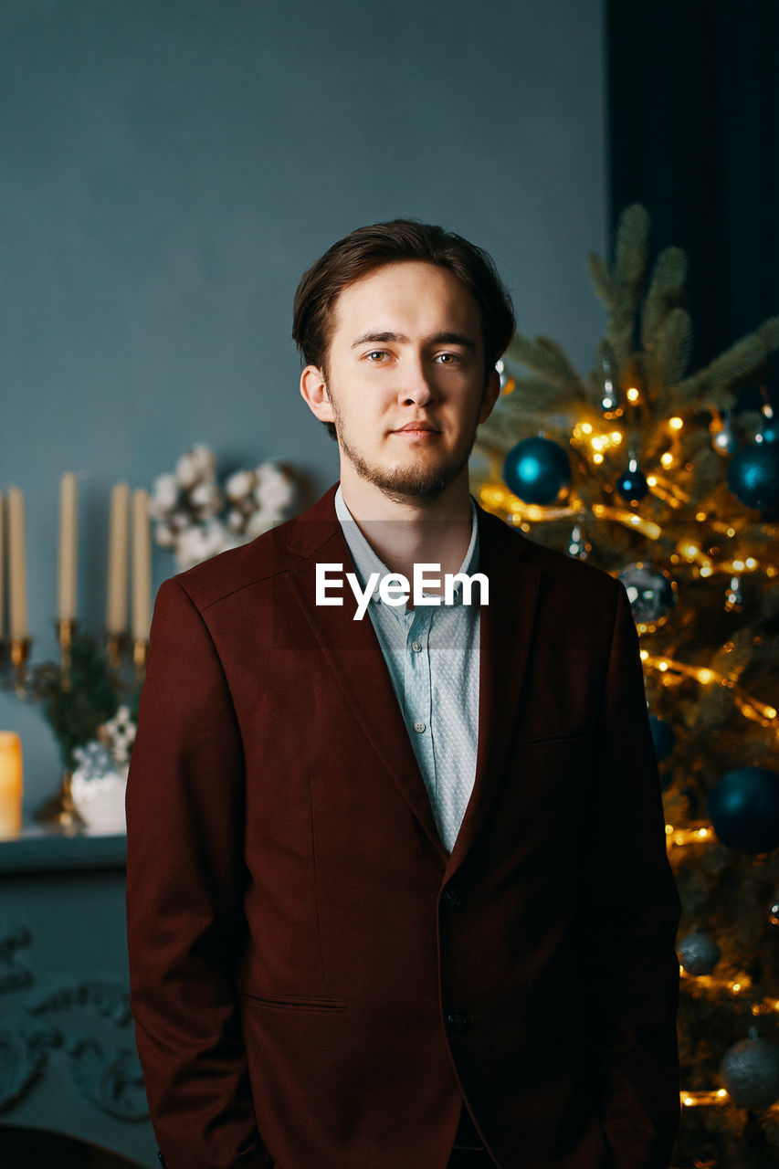 Portrait of young man standing at night