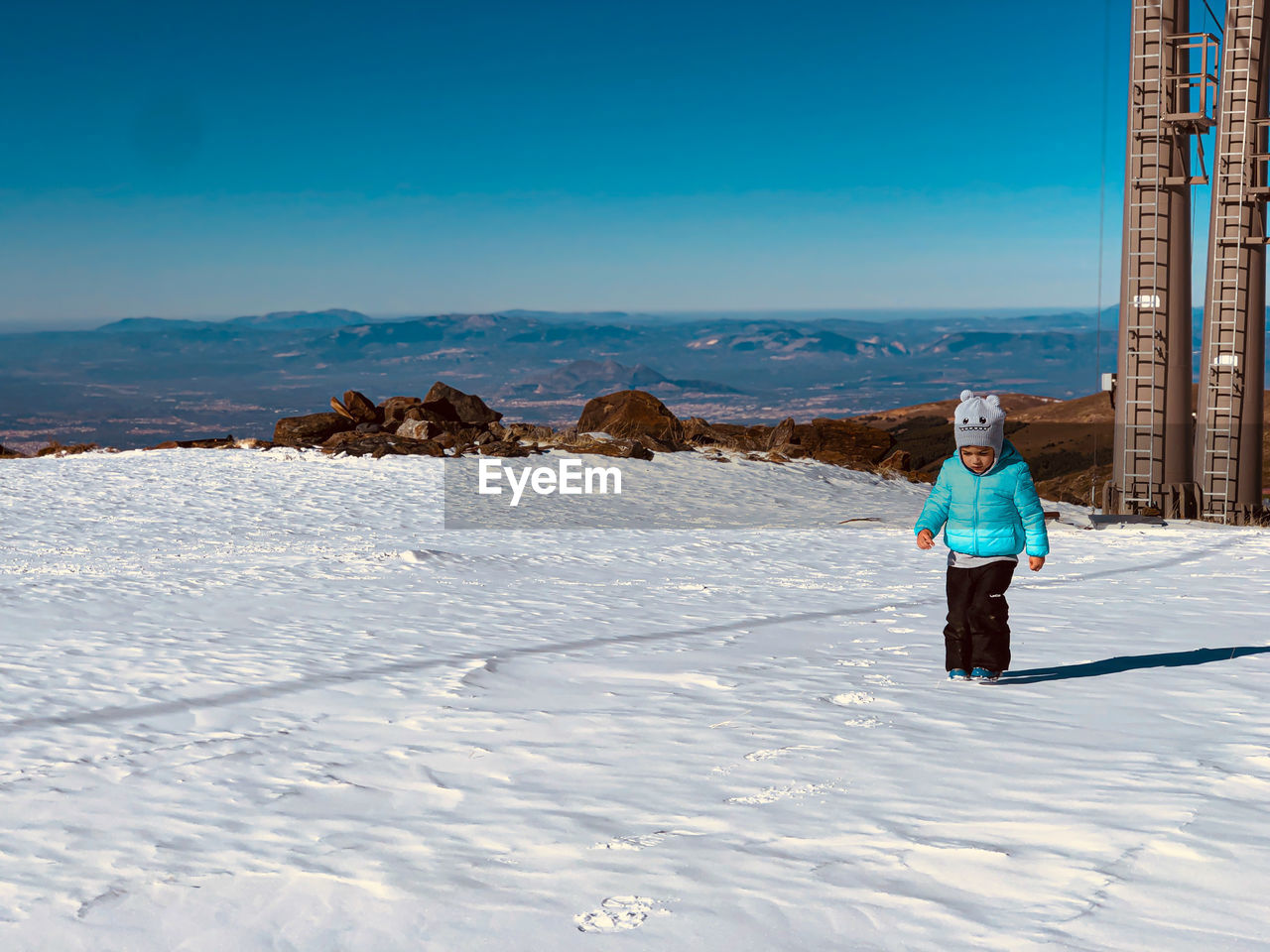 Little boy in the snow of the mountains of sierra nevada