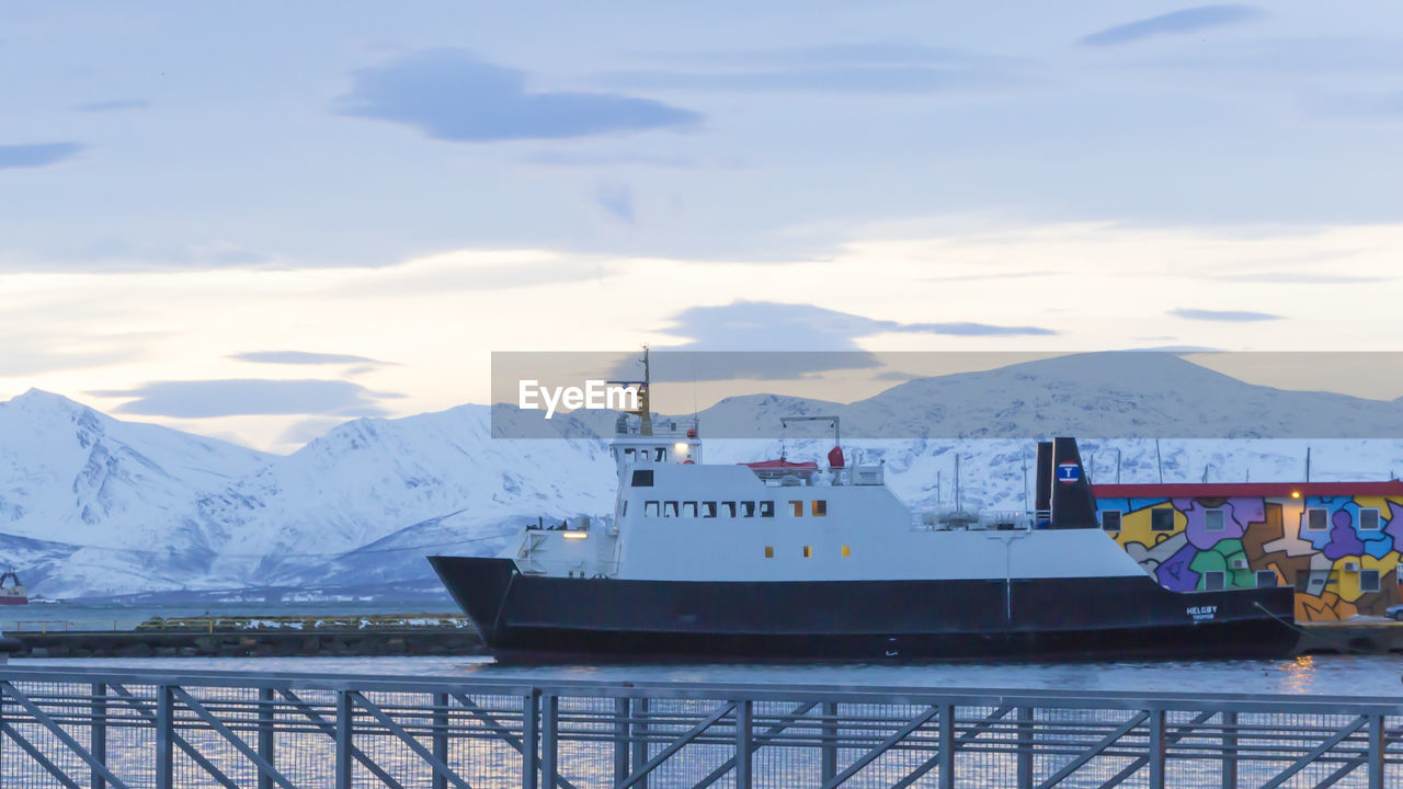 NAUTICAL VESSEL ON SNOWCAPPED MOUNTAINS AGAINST SKY