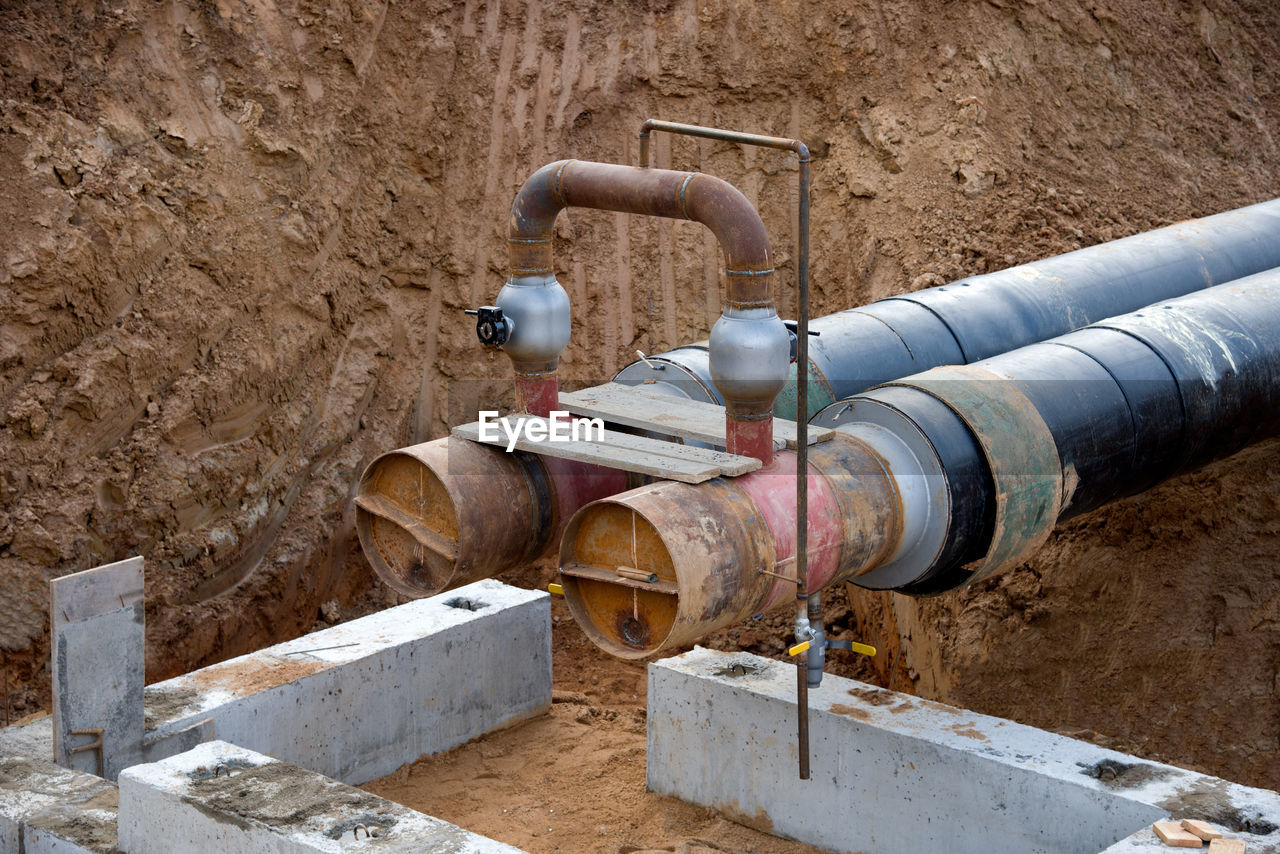 Laying heating pipes in a trench at construction site. installation underground storm system 