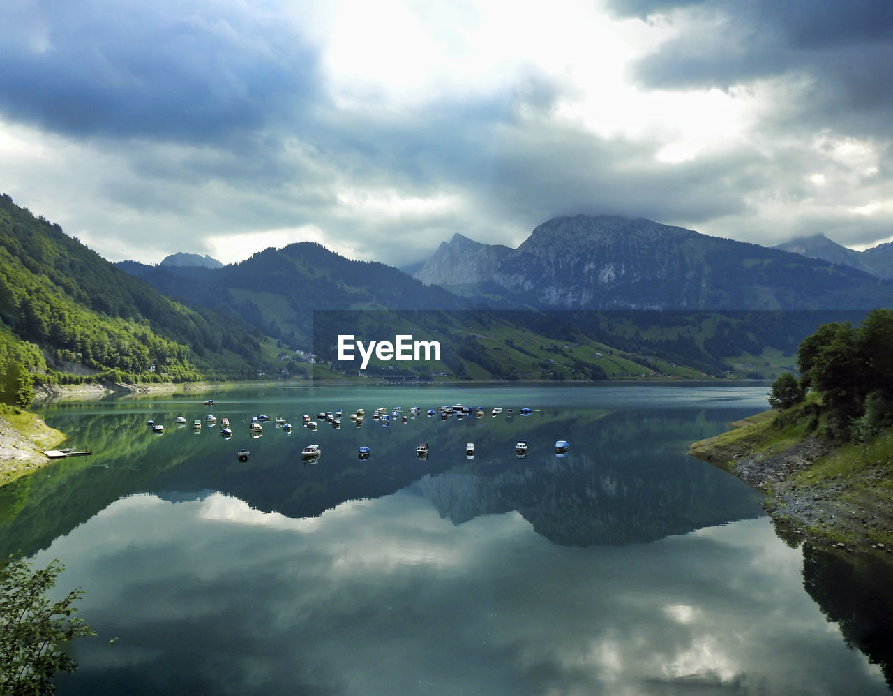 Scenic view of lake and mountains against sky