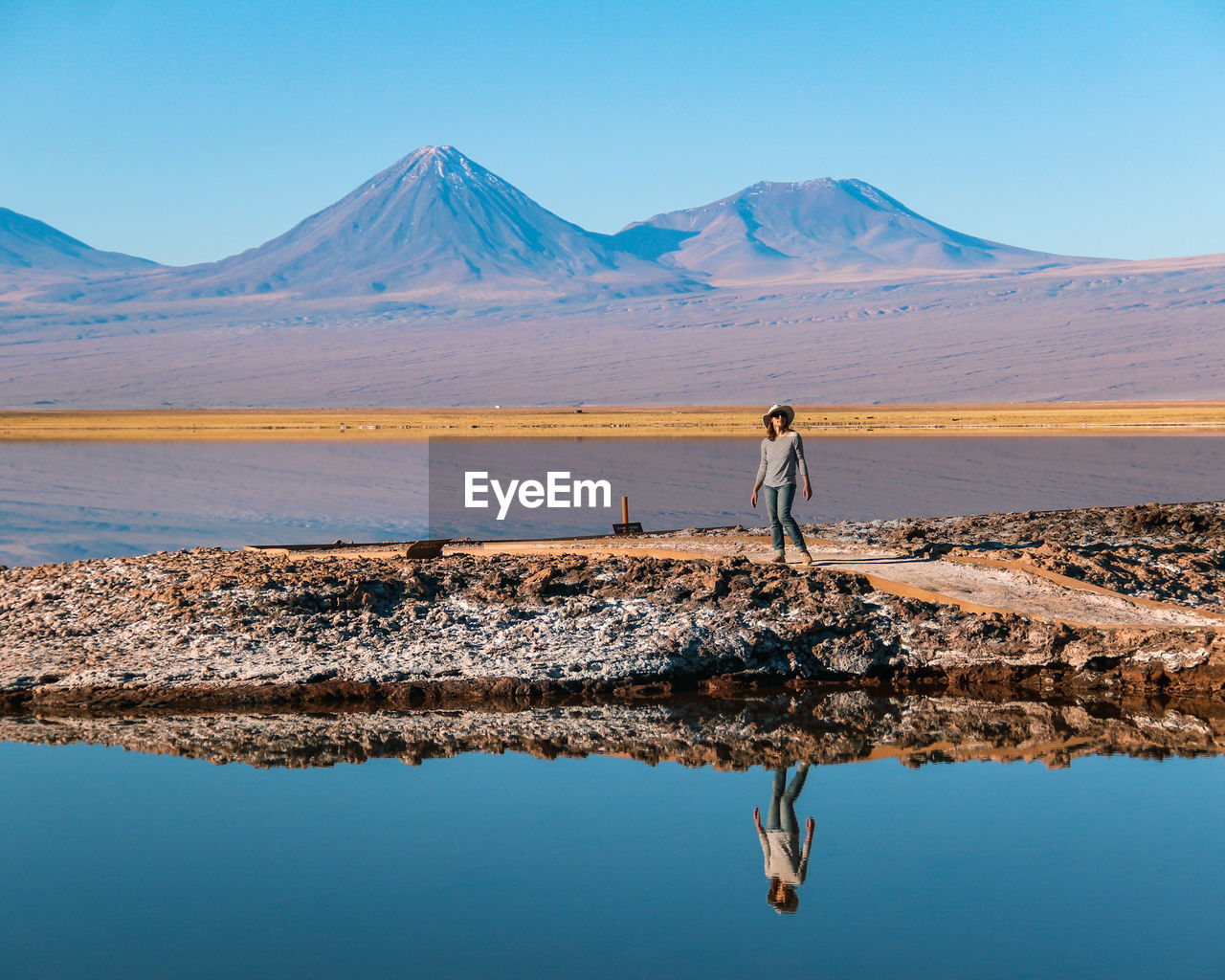 Scenic view of lake by mountains against sky