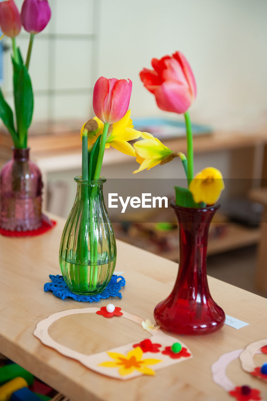 Close-up of tulips in vase on table at home