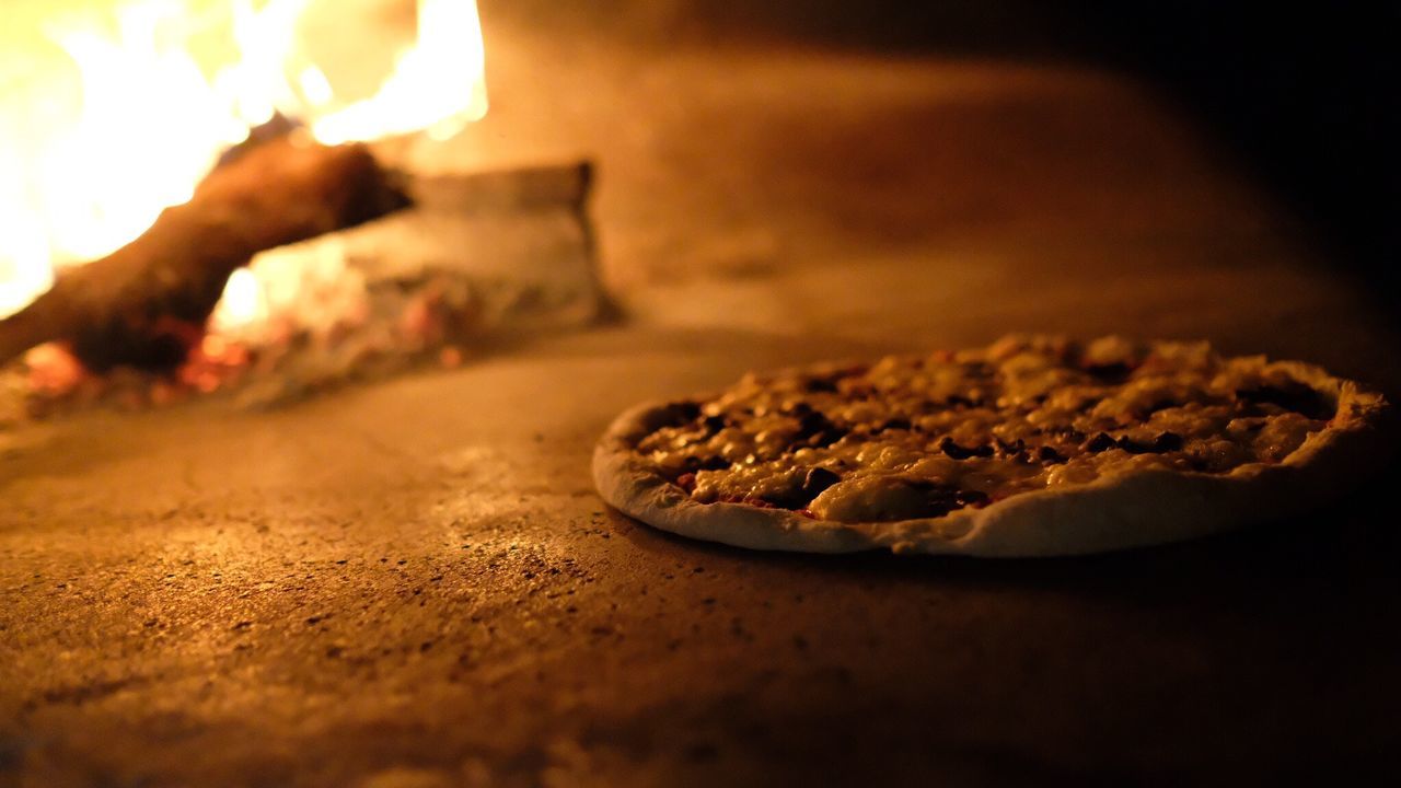 High angle view of pizza by fire