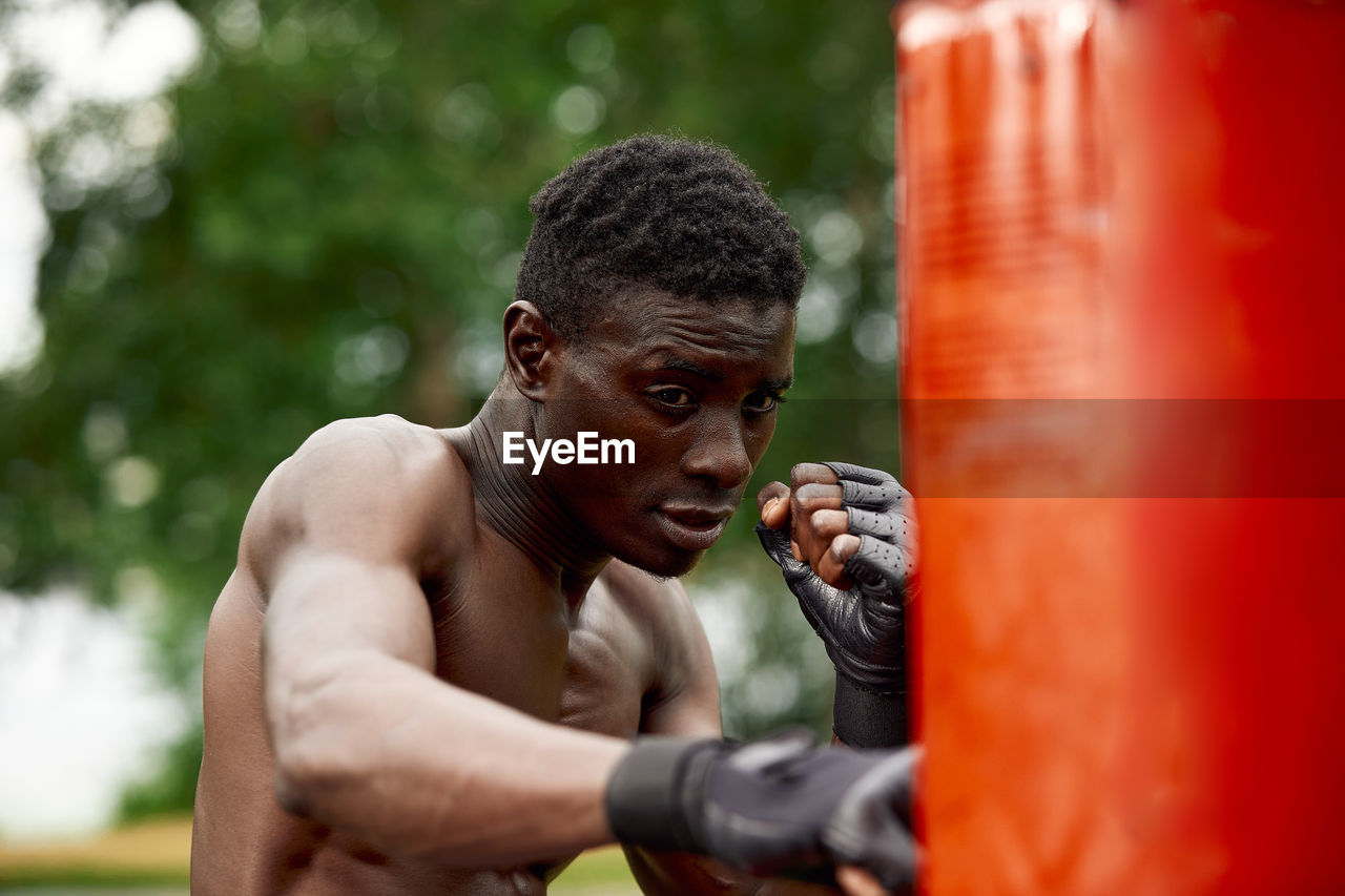 Young man boxing outdoors