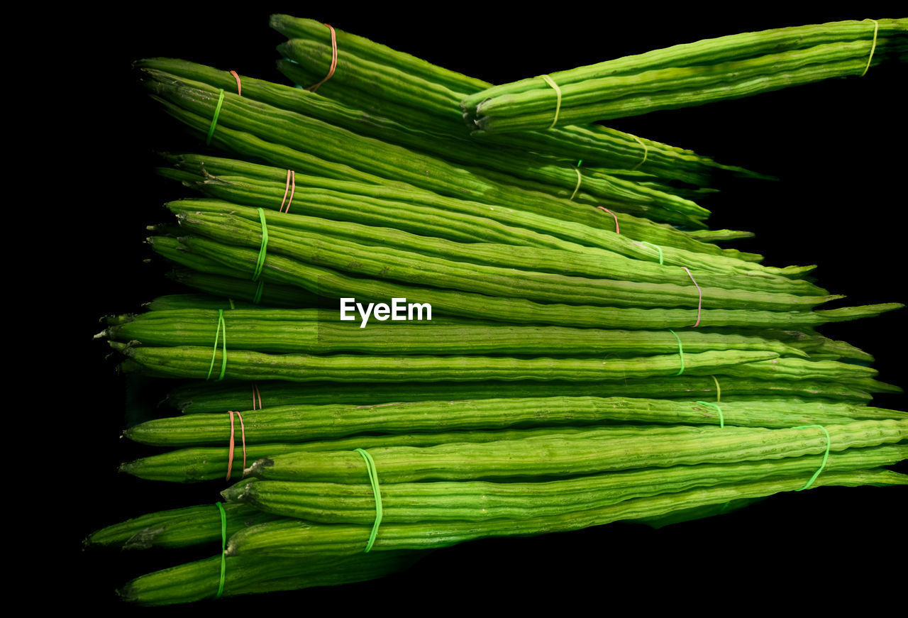 green, food and drink, food, black background, plant stem, studio shot, vegetable, healthy eating, freshness, wellbeing, indoors, no people, produce, bundle, asparagus, organic, raw food, still life, bunch, close-up, plant, nature, large group of objects, leaf