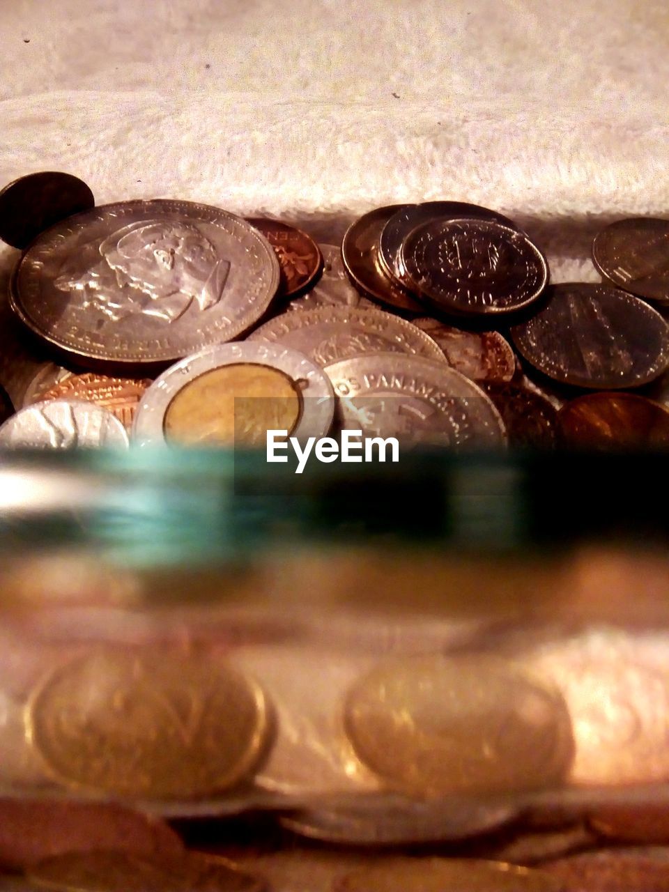 CLOSE-UP OF COINS IN CONTAINER