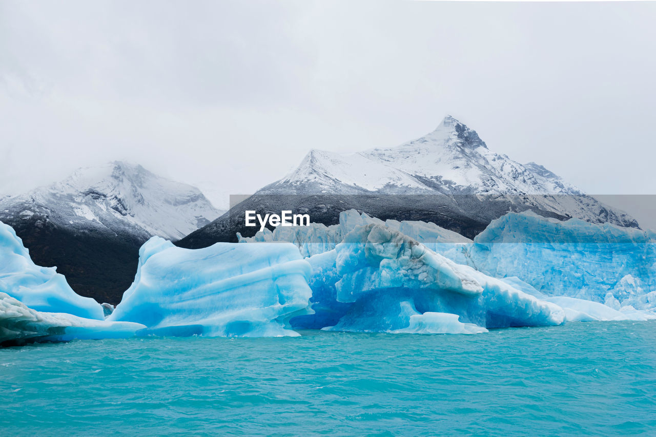 scenic view of snowcapped mountains against cloudy sky