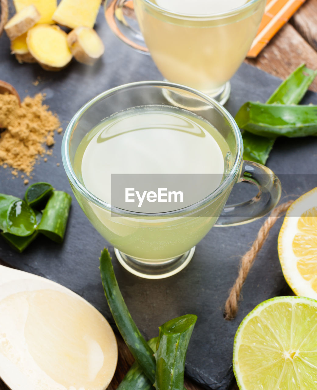 Aloe vera drink with lime and lemon. glass cups on a slate tray.