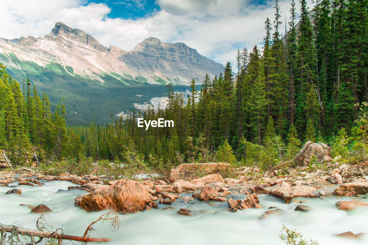 Scenic view of mountains against cloudy sky