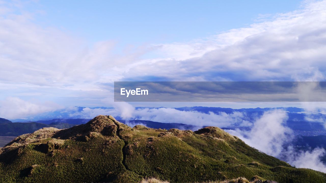 Scenic view of mountains against cloudy sky