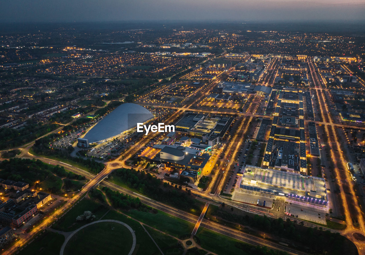 High angle view of city lit up at night