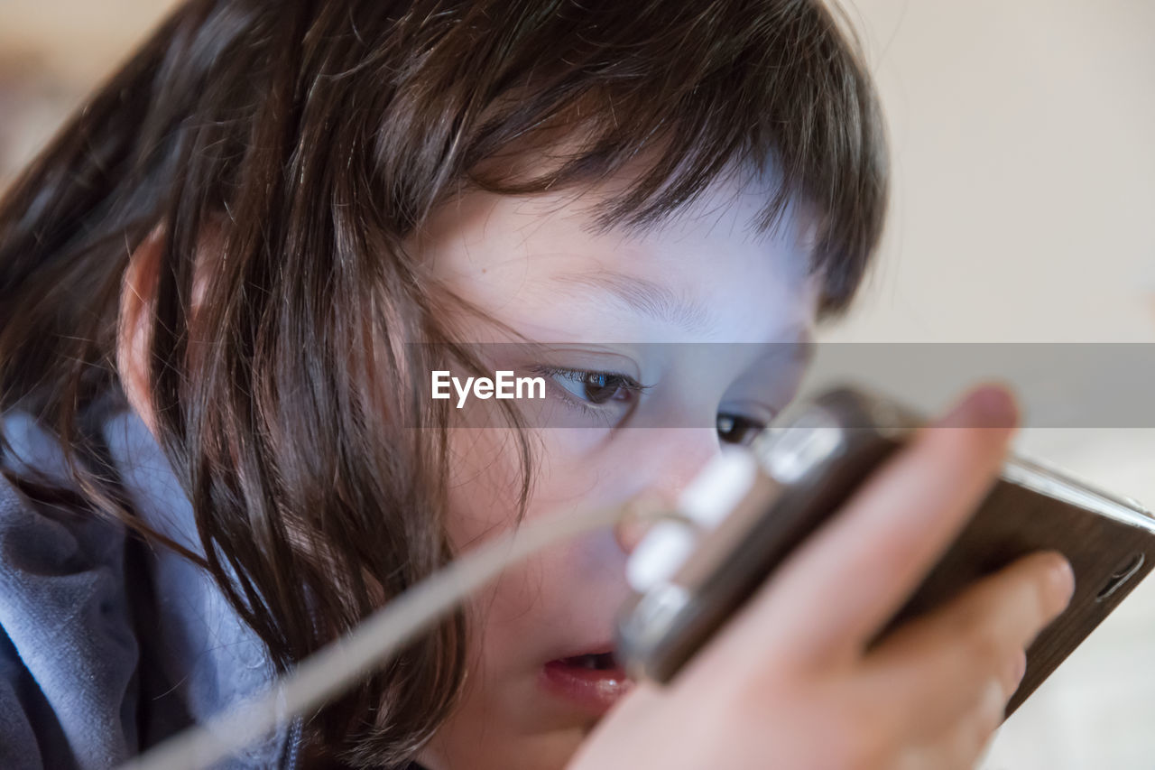 Close-up of girl using mobile phone