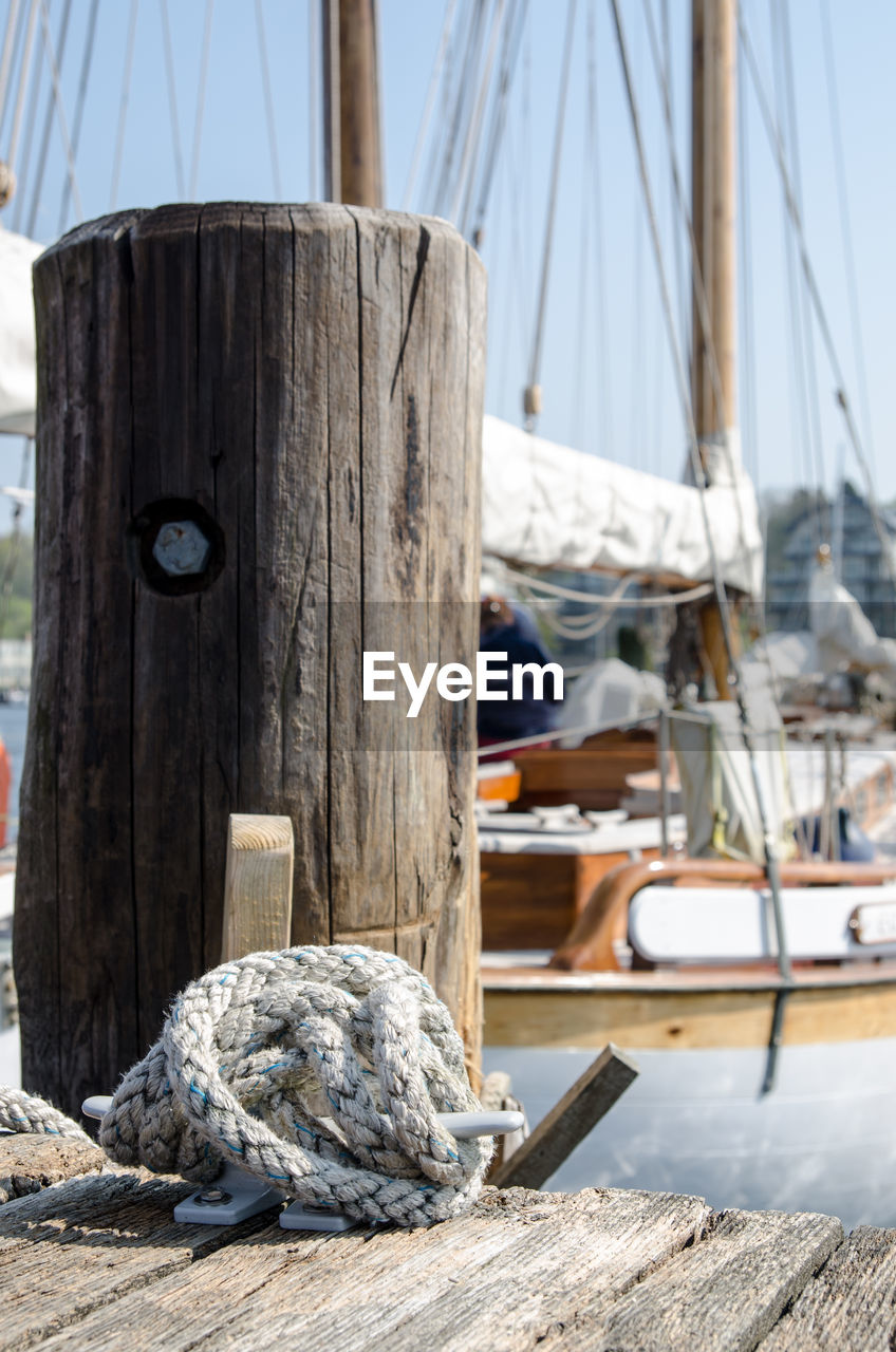 Close-up of sailboats moored at harbor