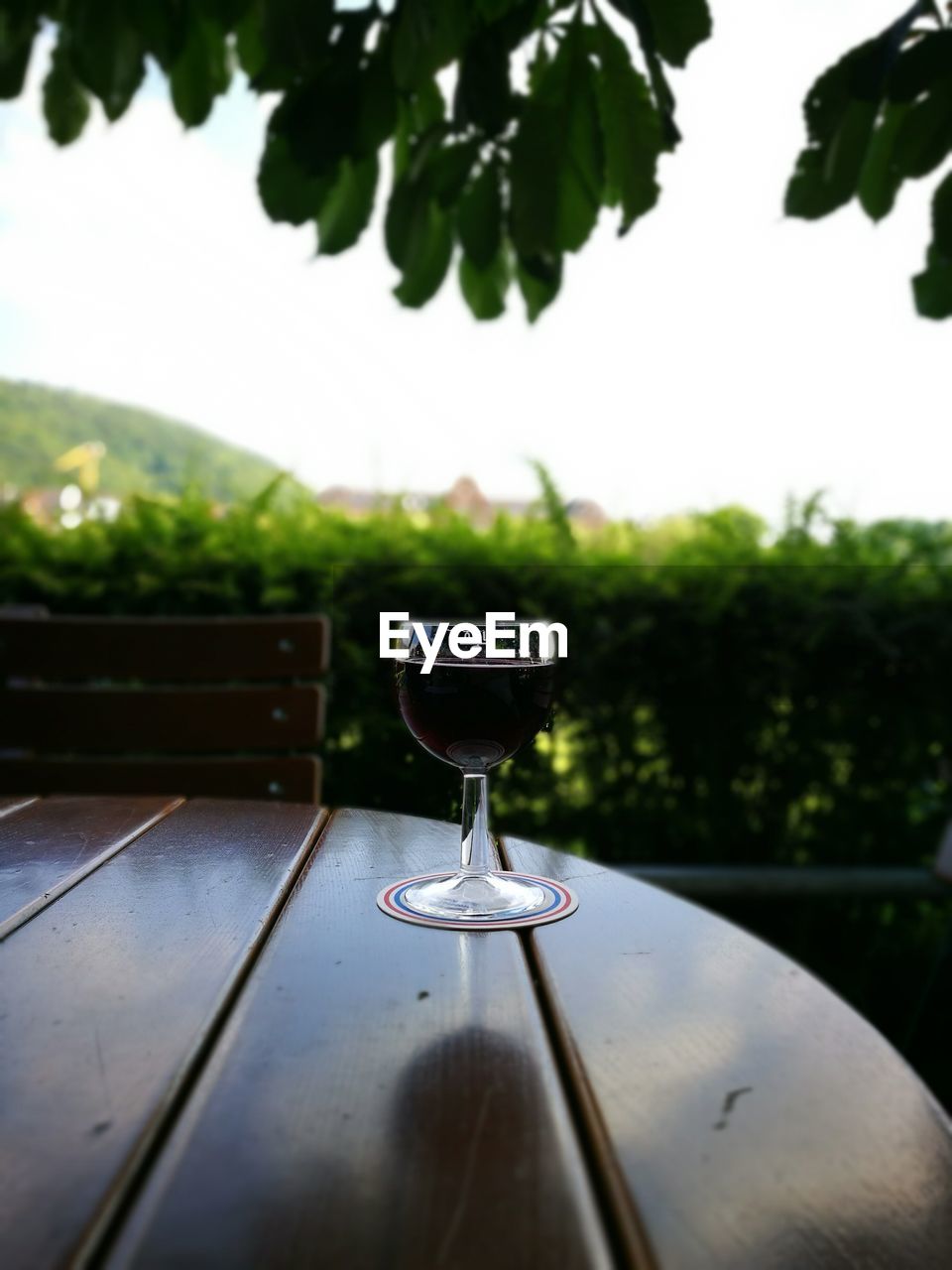 Wineglass on wooden table at outdoor restaurant