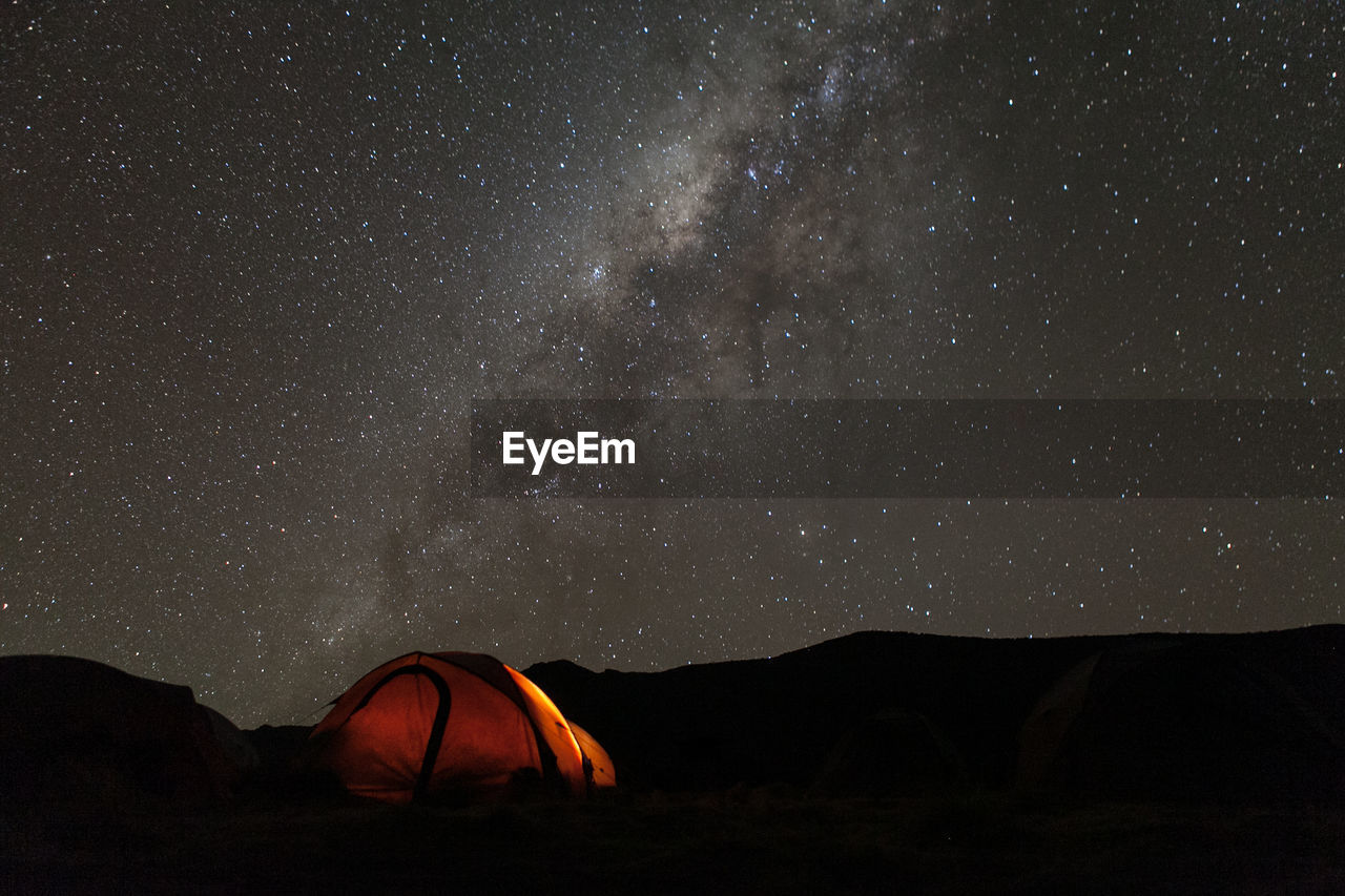 Tent on field against star field