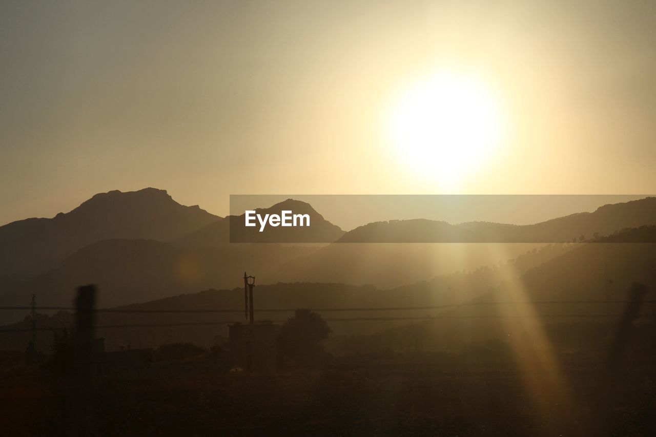 Scenic view of silhouette mountains against sky during sunset