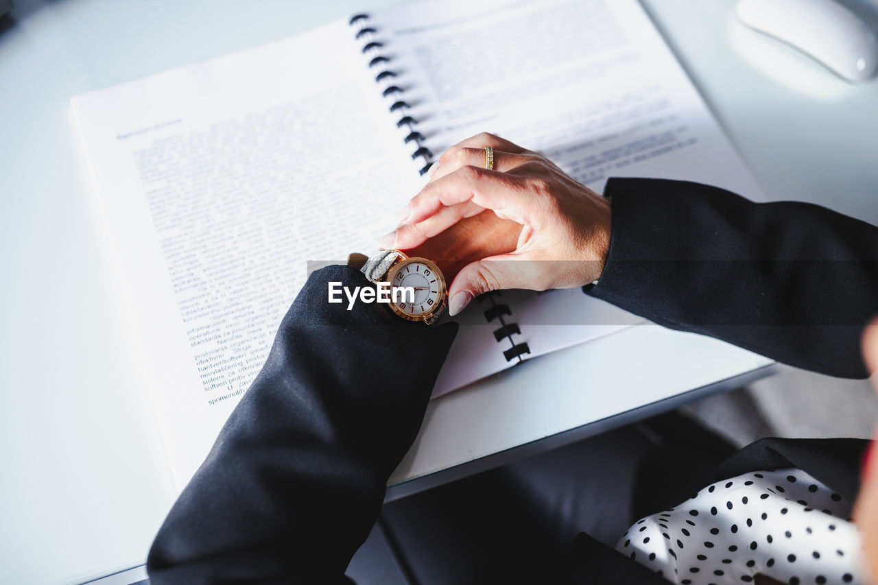 Businesswoman checking time in office