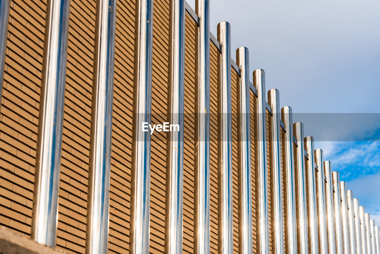 LOW ANGLE VIEW OF METAL STRUCTURE AGAINST SKY