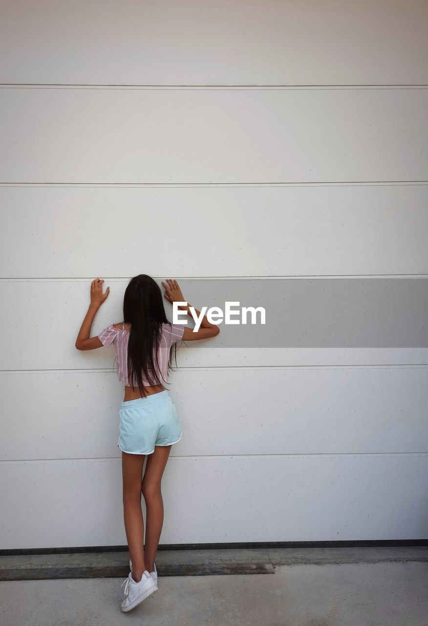 Girl touching the wall