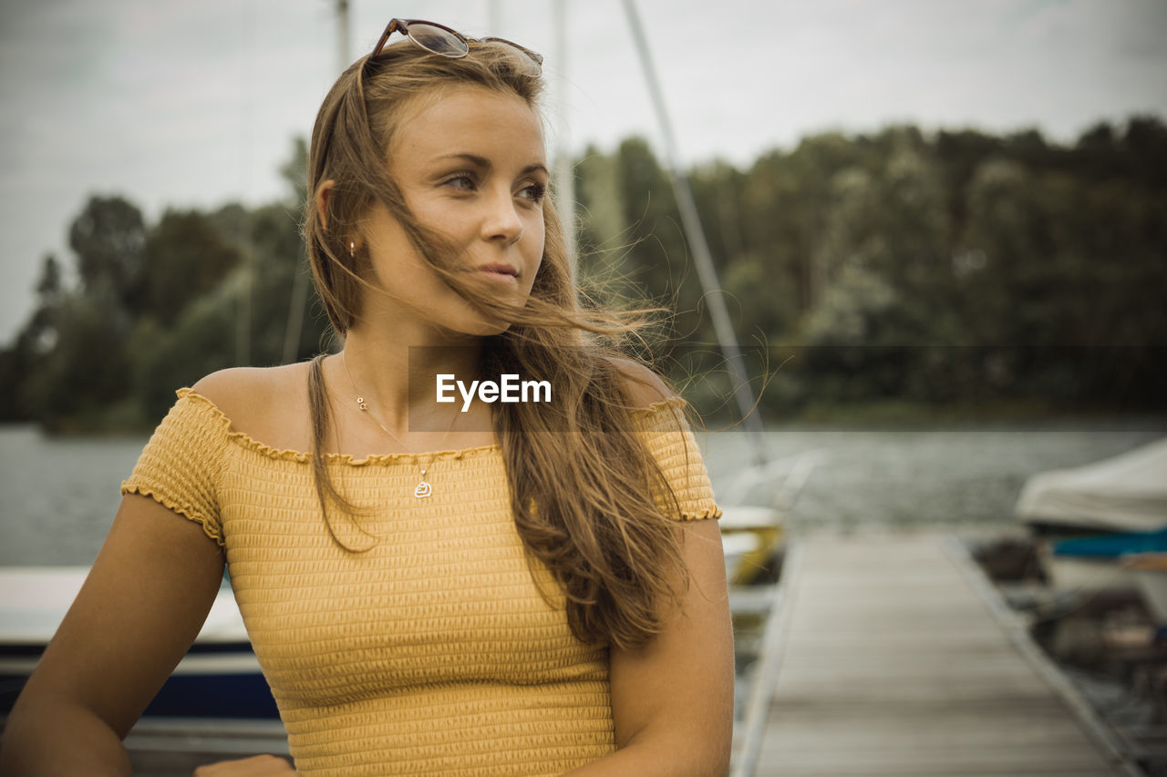 PORTRAIT OF YOUNG WOMAN LOOKING DOWN