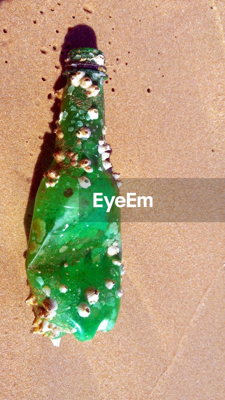 HIGH ANGLE VIEW OF MULTI COLORED SAND ON SANDY