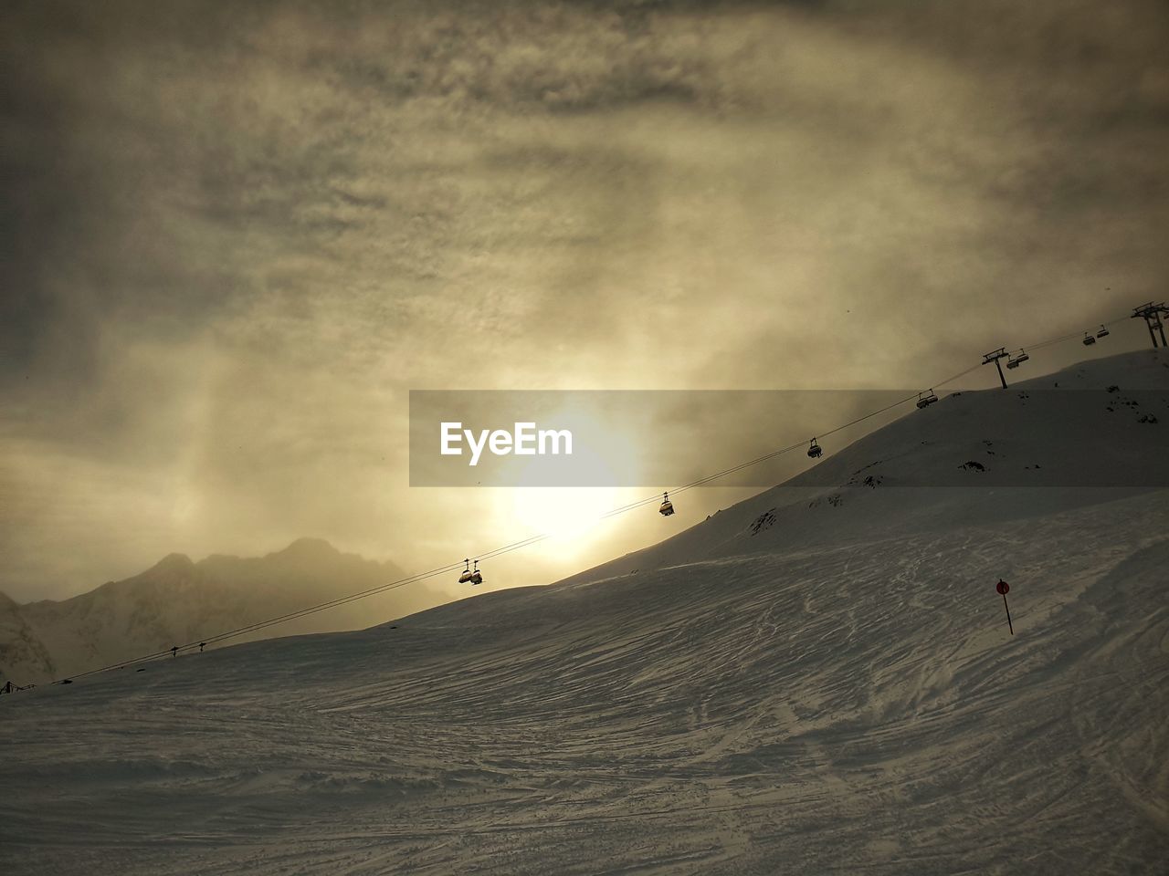 Scenic view of snowcapped mountains against sky - sunlight skiing