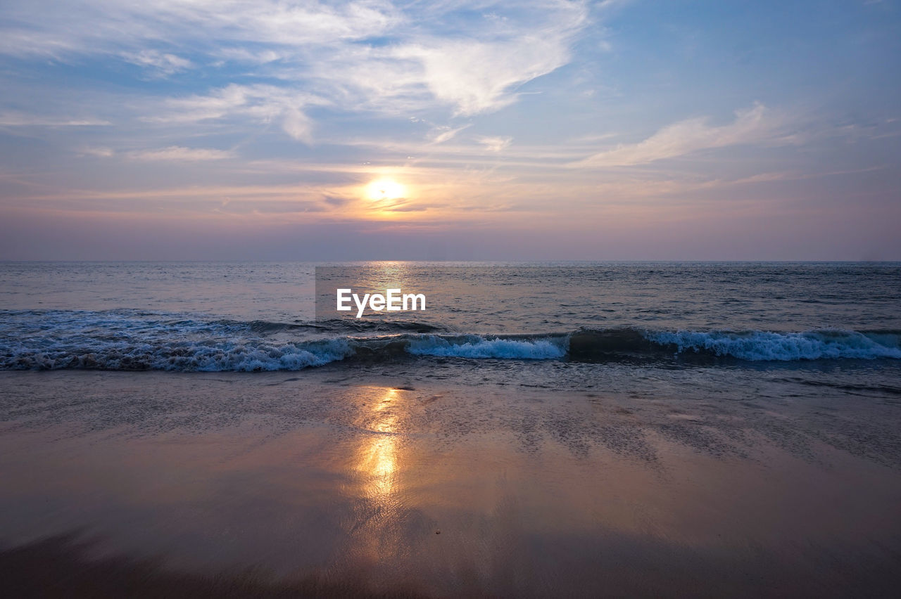 scenic view of beach against sky during sunset