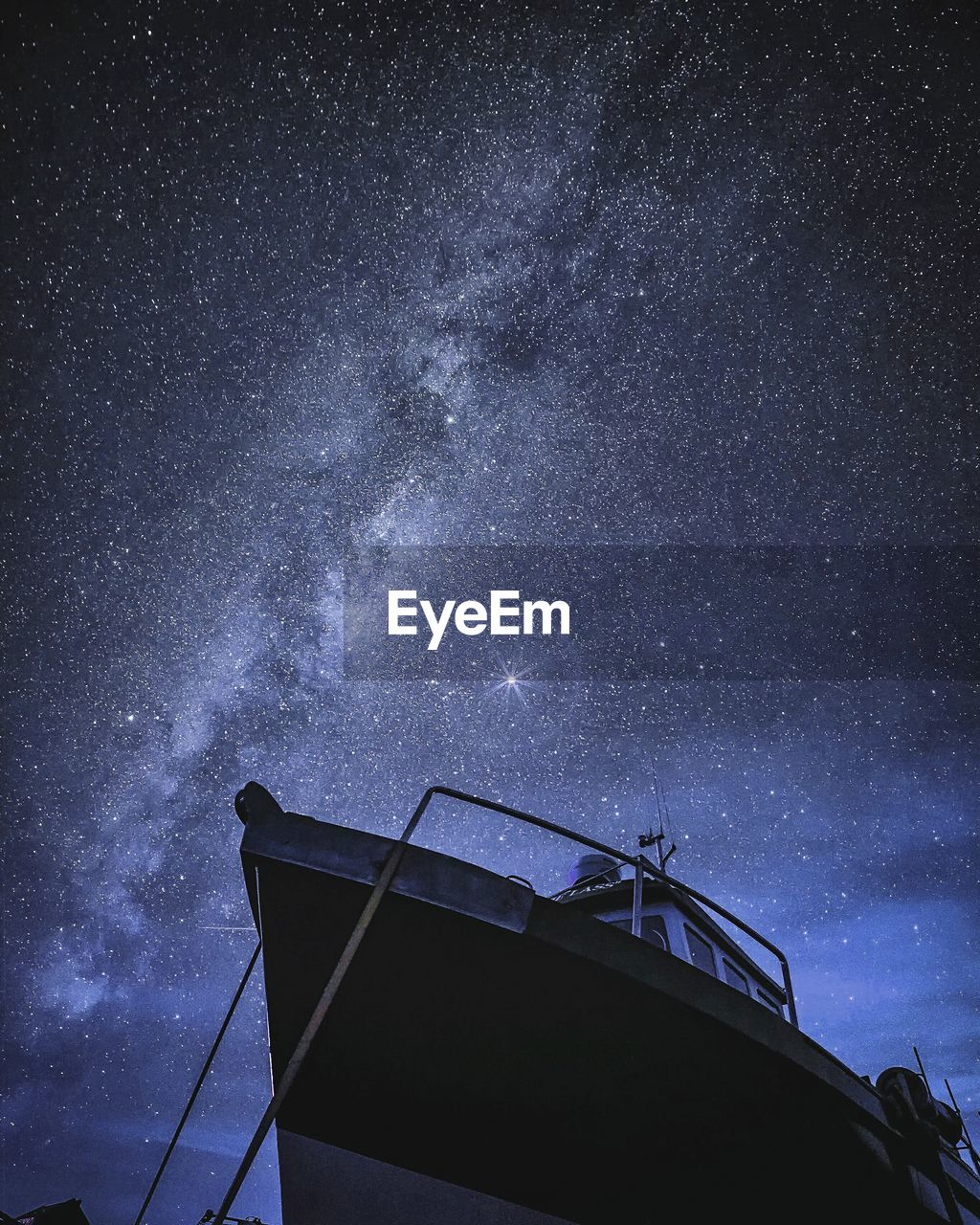 Low angle view of boat against nebula in sky at night