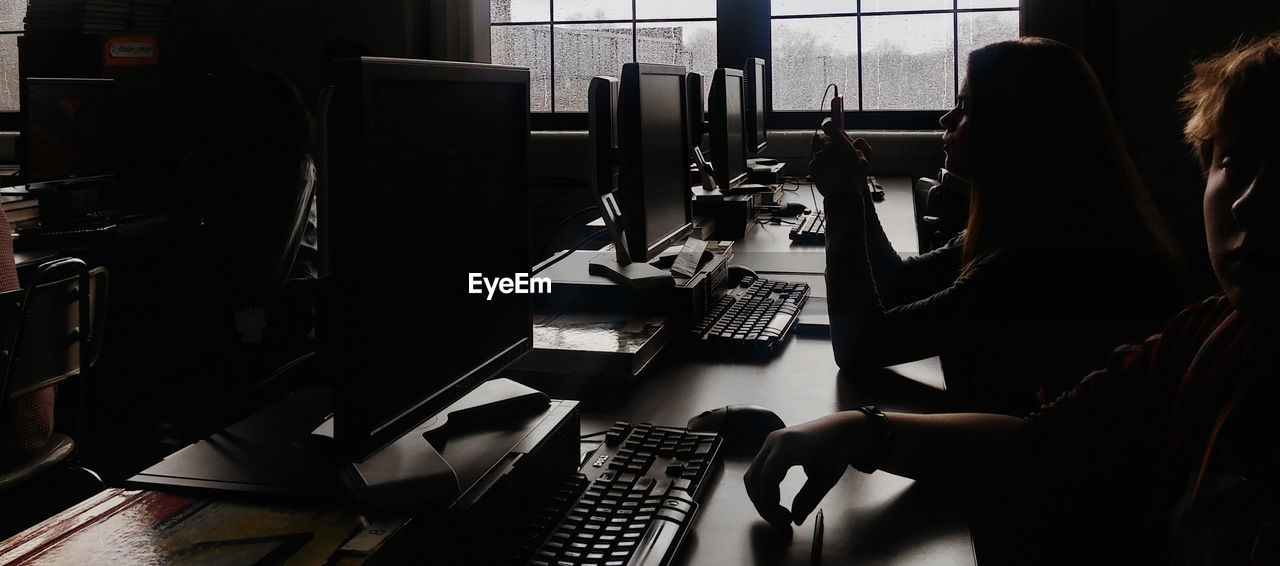 Students using computers in school during rainy season