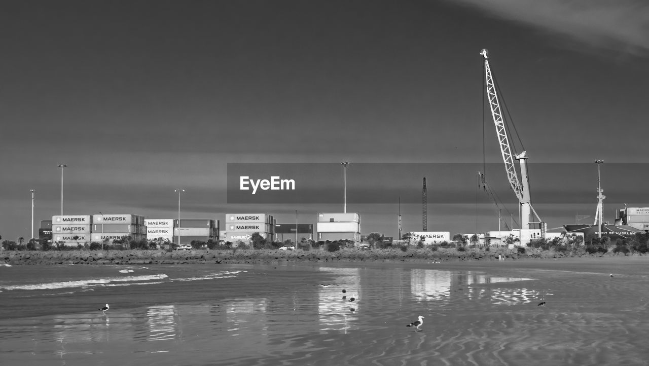 water, black and white, sky, monochrome photography, monochrome, architecture, industry, built structure, nature, sea, pier, nautical vessel, transportation, harbor, building exterior, no people, outdoors, crane - construction machinery, power generation, day, environment, beach, skyline, business, vehicle, dock, factory, commercial dock, stadium