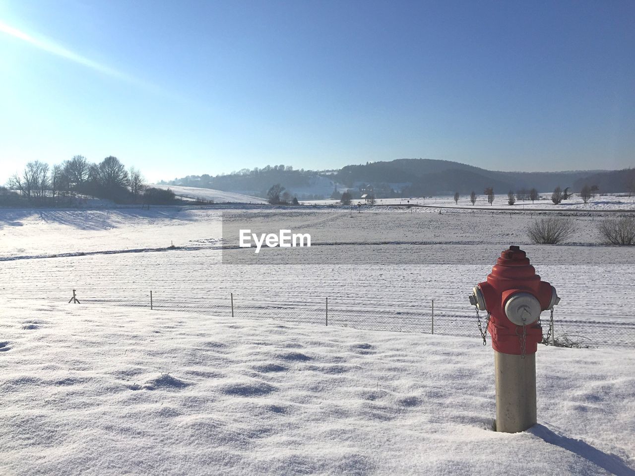 Fire hydrant on snowcapped field during winter