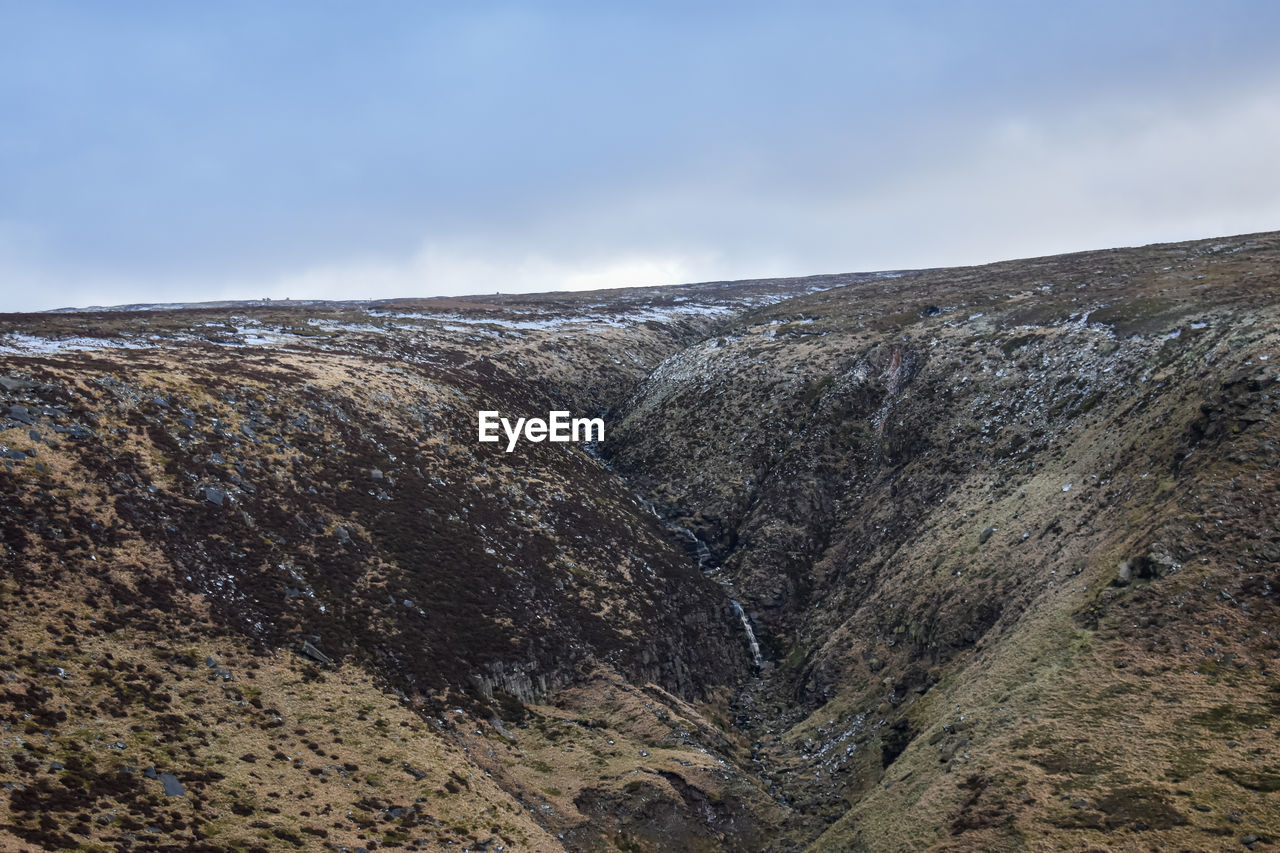 environment, rock, landscape, sky, mountain, scenics - nature, nature, geology, ridge, cloud, beauty in nature, land, wilderness, cliff, no people, terrain, non-urban scene, outdoors, day, tranquility, plateau, travel destinations, extreme terrain, tranquil scene, travel, mountain range, sea