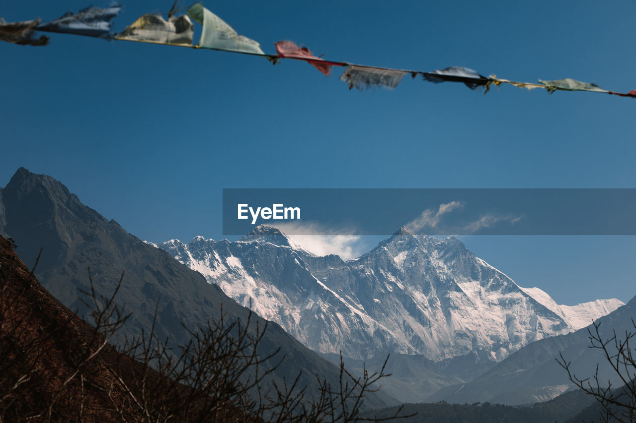 Low angle view of snowcapped mountains against sky