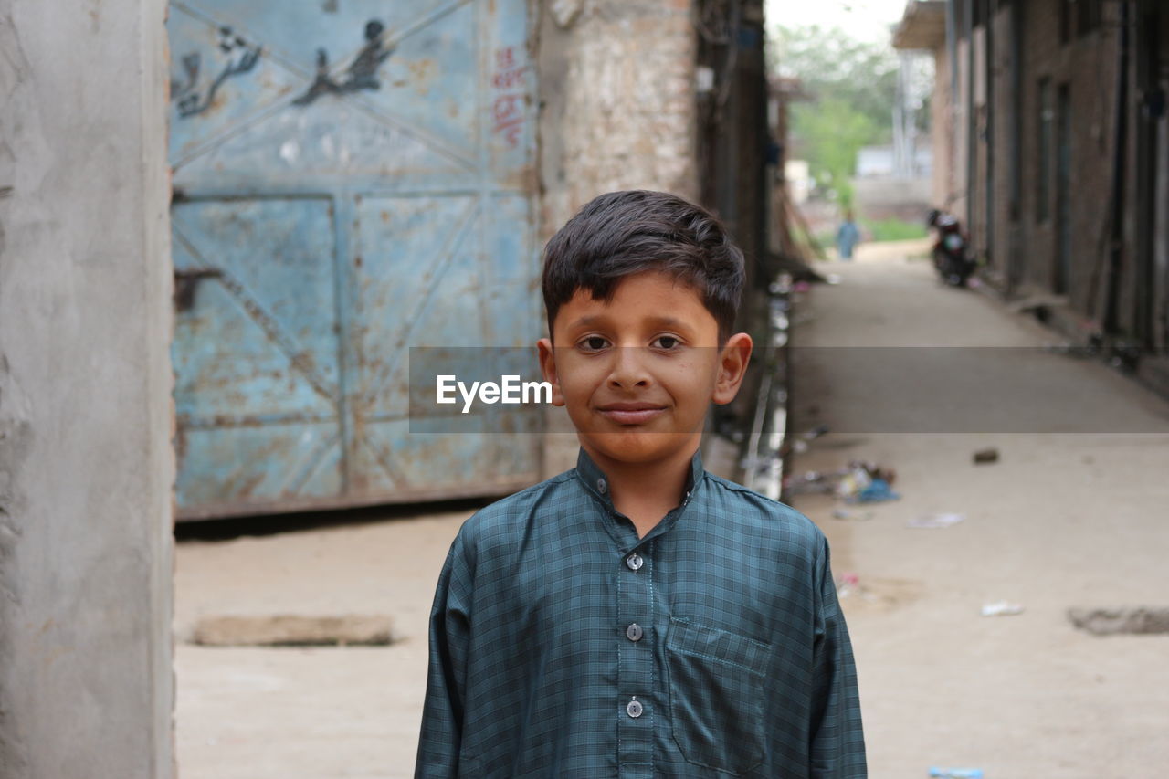 Portrait of child standing in city