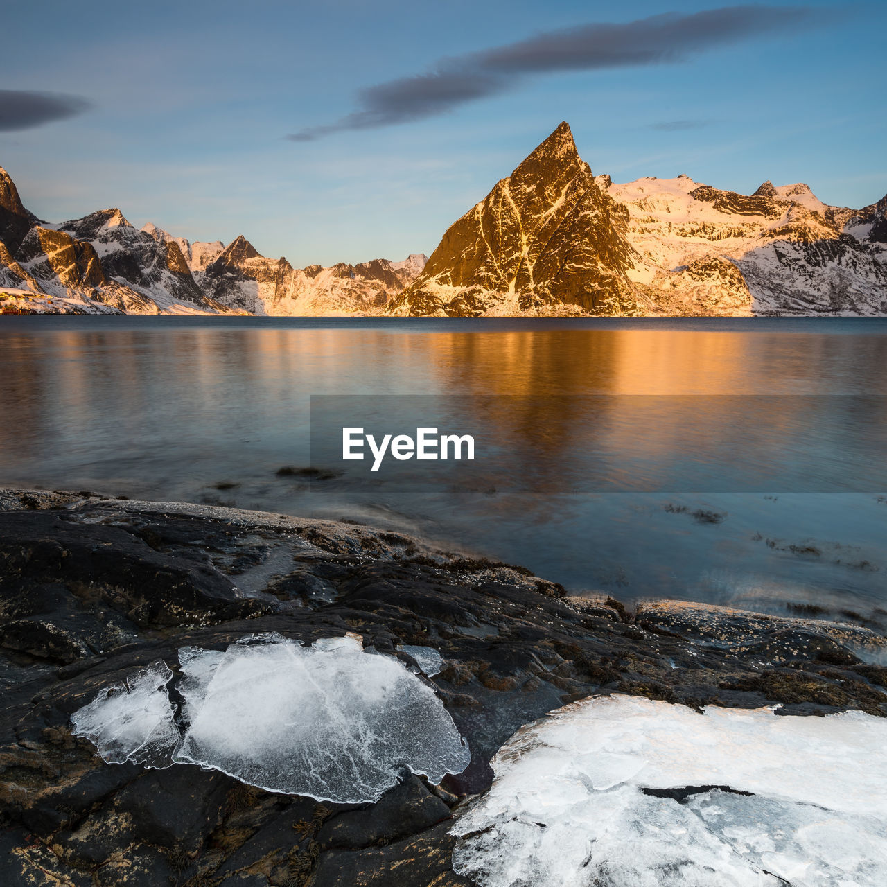 SCENIC VIEW OF FROZEN LAKE AGAINST SKY