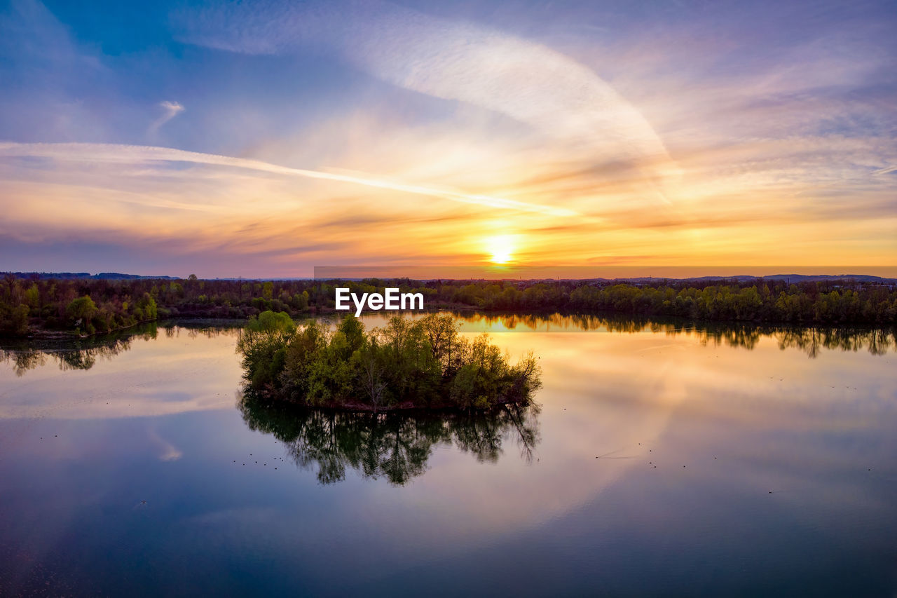 Scenic view of lake against sky during sunset