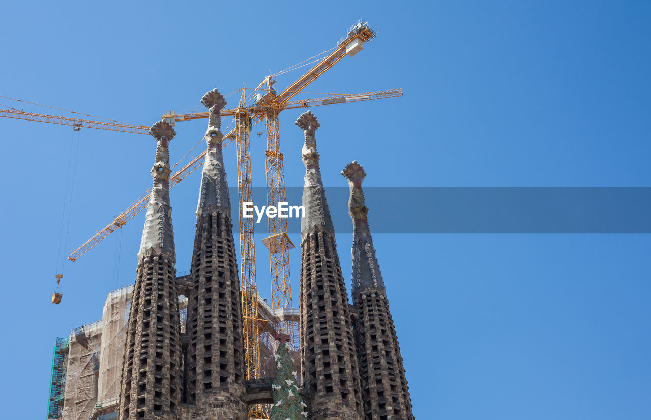 Low angle view of sagrada familia against clear blue sky
