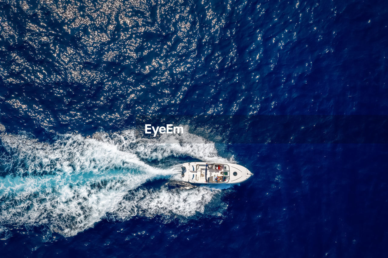 Aerial view of man driving motorboat in sea