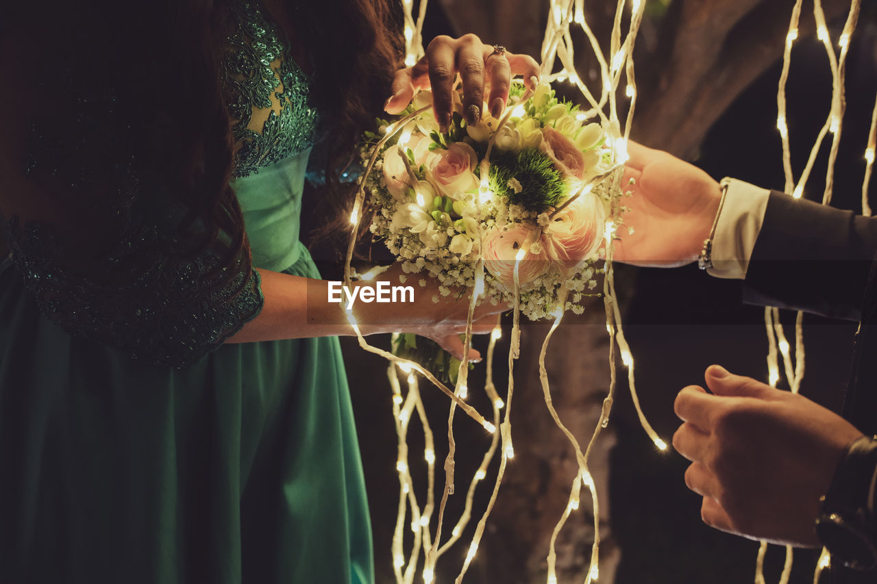 Midsection of woman holding flower bouquet